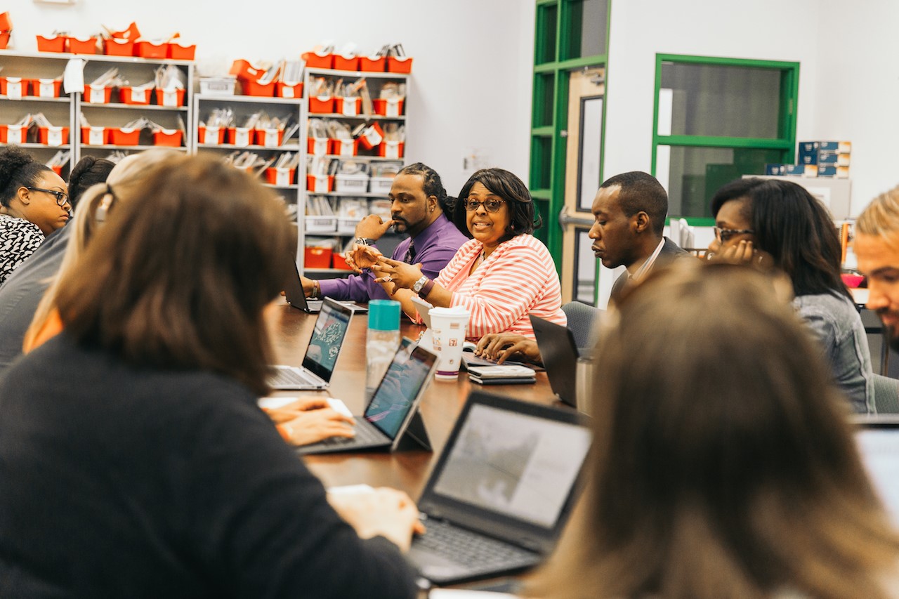 Turner leads a staff meeting with some of her 18 curriculum specialists, who are responsible for helping teachers develop lesson plans that achieve desirable student achievement goals. 