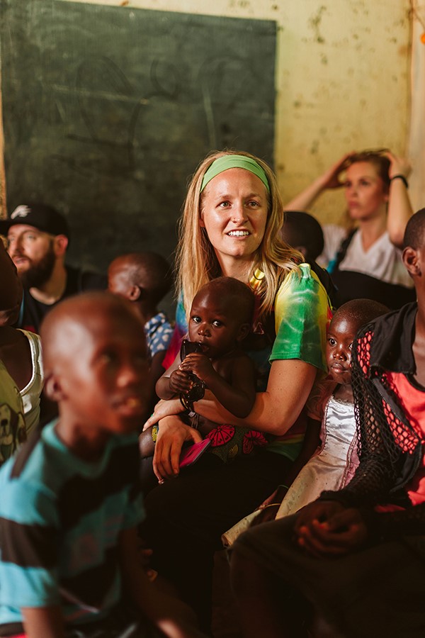 Movement employee with Ugandan students