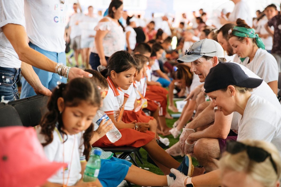 Volunteers helping kids with schools