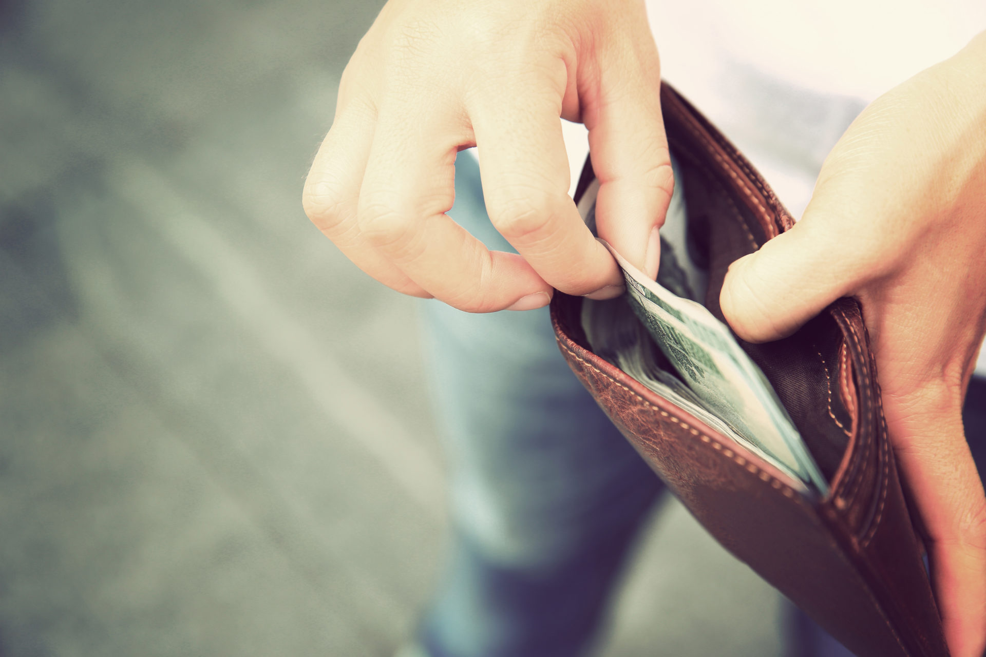 Hands taking us dollars out from wallet on the street